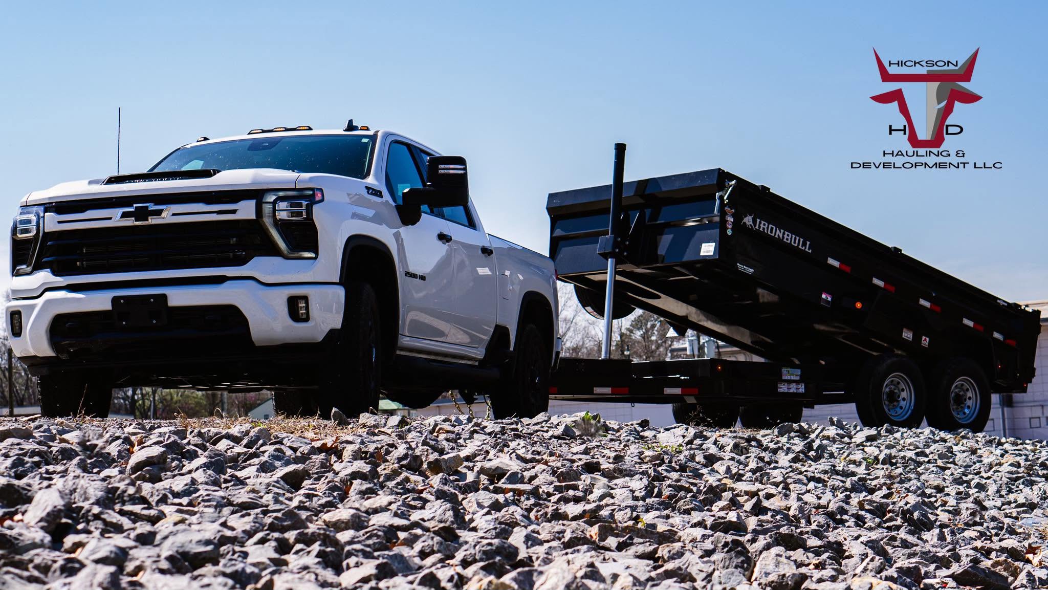 Hickson’s white Chevrolet truck and black dump trailer on gravel